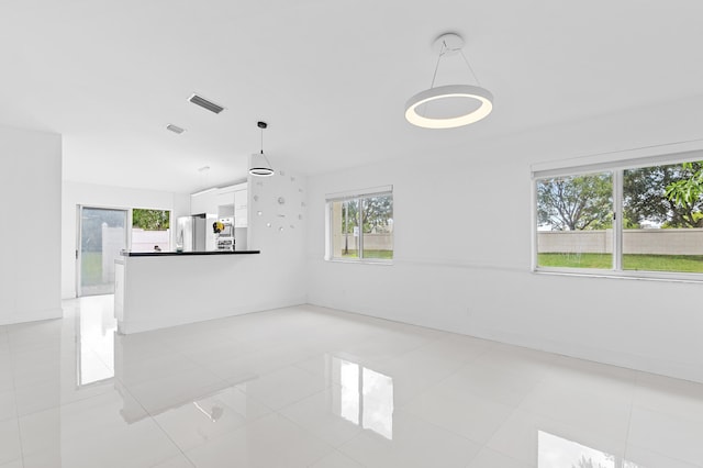 unfurnished living room with light tile patterned floors