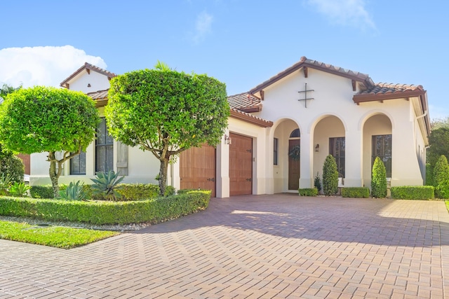 mediterranean / spanish-style house with a garage