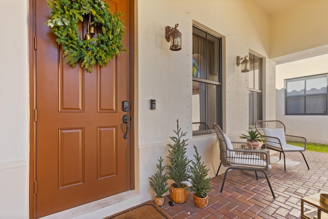 view of exterior entry with a porch