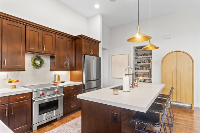 kitchen with pendant lighting, plenty of natural light, sink, and stainless steel appliances