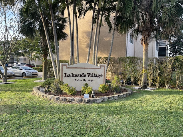 community sign featuring a lawn