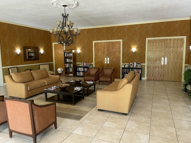 living area featuring an inviting chandelier, ornamental molding, light tile patterned flooring, a textured ceiling, and wallpapered walls