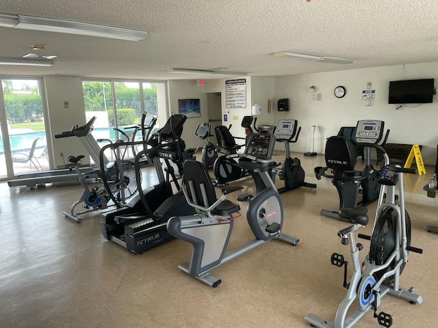 exercise room featuring a textured ceiling