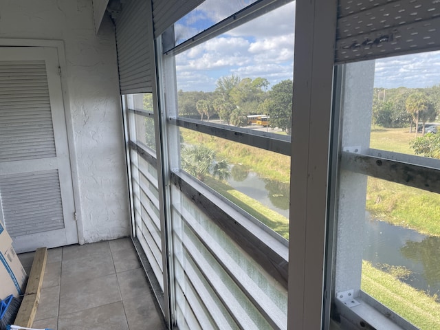 sunroom / solarium with a water view