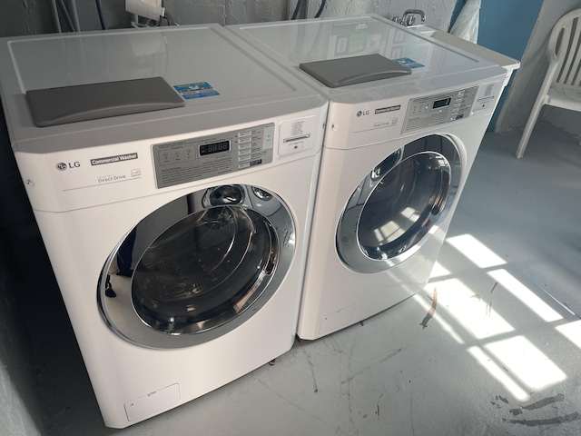 washroom with laundry area, washer and clothes dryer, and marble finish floor