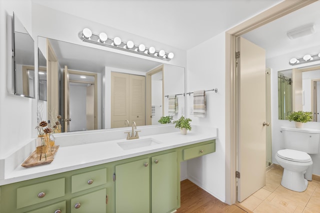 bathroom featuring tile patterned floors, vanity, and toilet