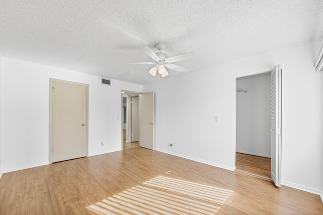 spare room with ceiling fan, hardwood / wood-style floors, and a textured ceiling