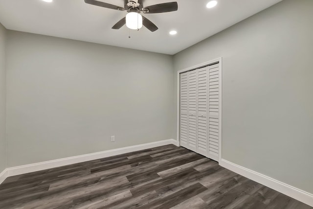 unfurnished bedroom with ceiling fan, dark hardwood / wood-style flooring, and a closet