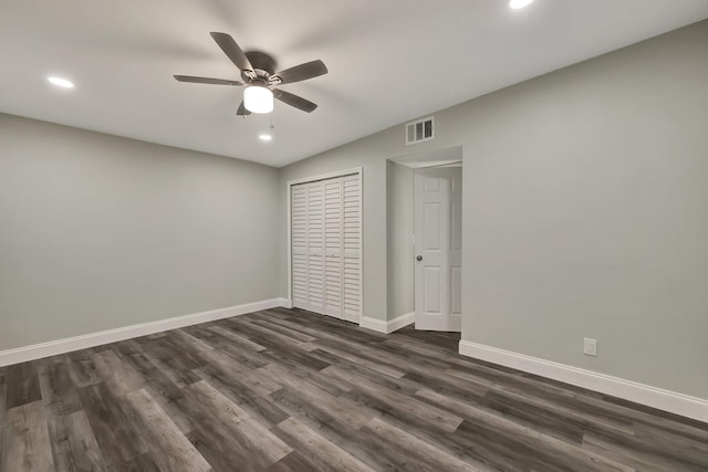 unfurnished bedroom with ceiling fan, dark hardwood / wood-style flooring, and a closet