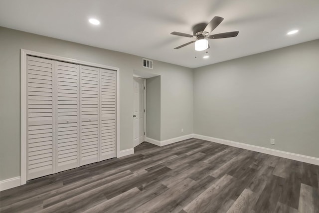 unfurnished bedroom with ceiling fan, a closet, and dark wood-type flooring