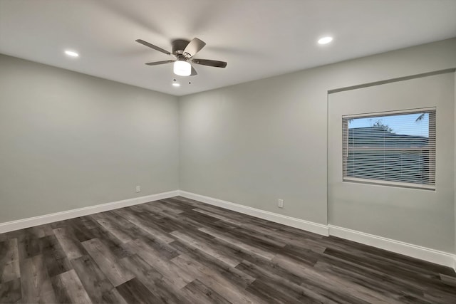 unfurnished room with ceiling fan and dark hardwood / wood-style flooring