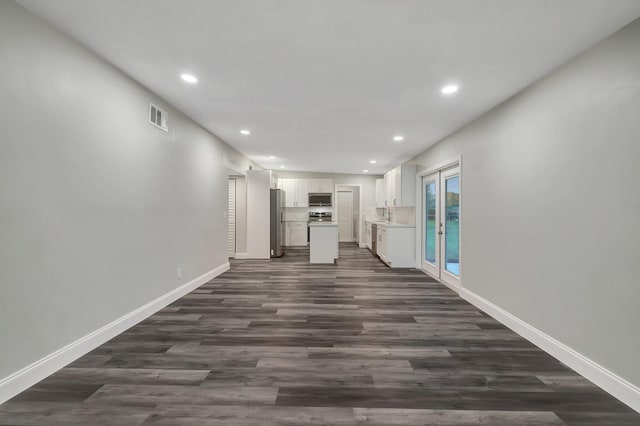 unfurnished living room featuring dark wood-type flooring