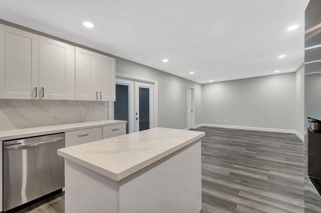 kitchen with white cabinets, dishwasher, a kitchen island, and dark hardwood / wood-style flooring