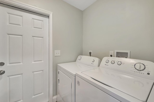 clothes washing area with washing machine and dryer