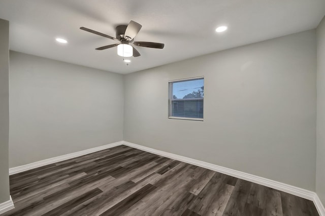 spare room with ceiling fan and dark wood-type flooring