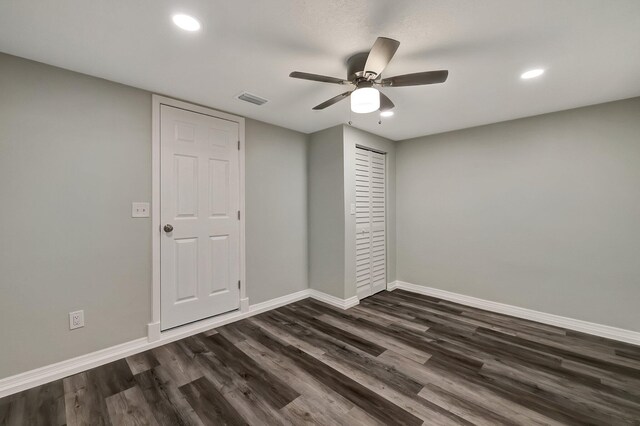 unfurnished bedroom featuring a closet, ceiling fan, and dark wood-type flooring