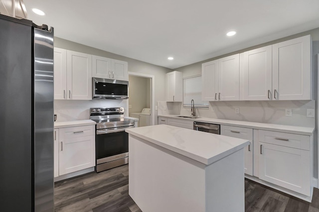 kitchen with a center island, white cabinetry, sink, and appliances with stainless steel finishes