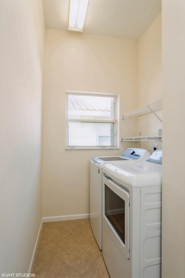 laundry room with light tile patterned floors and washing machine and dryer