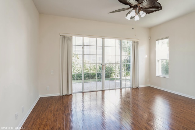 empty room featuring dark hardwood / wood-style flooring and ceiling fan