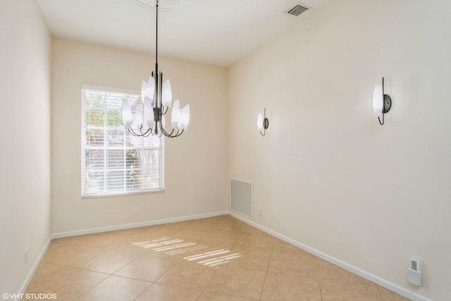 unfurnished dining area with light tile patterned floors and an inviting chandelier