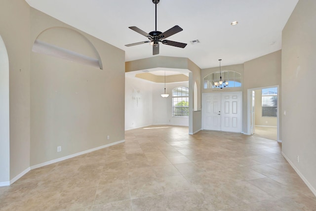 entryway featuring ceiling fan with notable chandelier