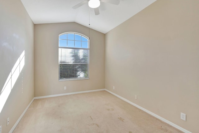 unfurnished room with light colored carpet, vaulted ceiling, and ceiling fan