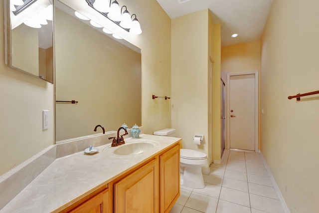 bathroom featuring tile patterned floors, vanity, and toilet