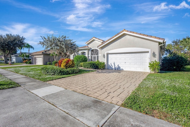 ranch-style house with a garage and a front lawn