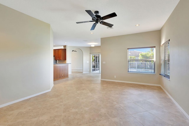 empty room with light tile patterned floors and ceiling fan