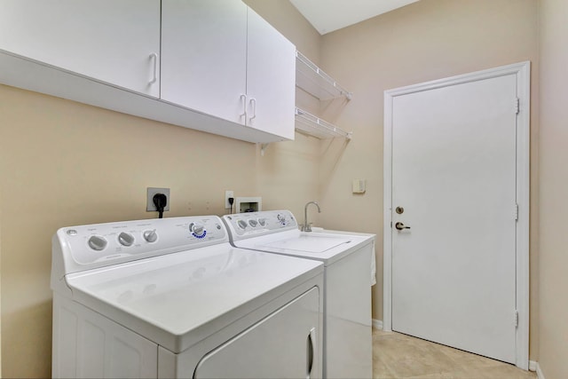 washroom featuring cabinets and independent washer and dryer