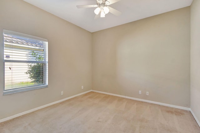 carpeted empty room featuring ceiling fan