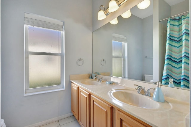 bathroom with tile patterned floors, curtained shower, vanity, and toilet