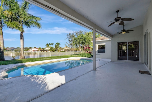 view of pool featuring a patio area, ceiling fan, and a water view