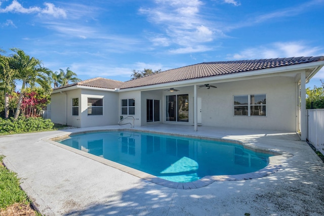 view of swimming pool with ceiling fan and a patio area