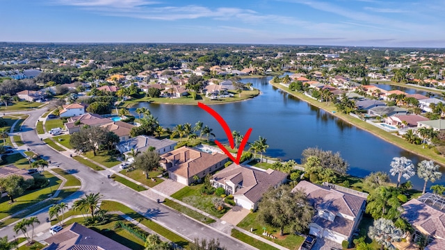 birds eye view of property with a water view