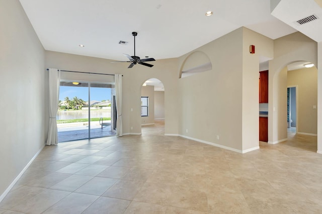 tiled spare room featuring ceiling fan