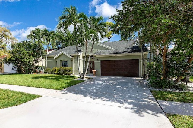 ranch-style home featuring a garage and a front yard