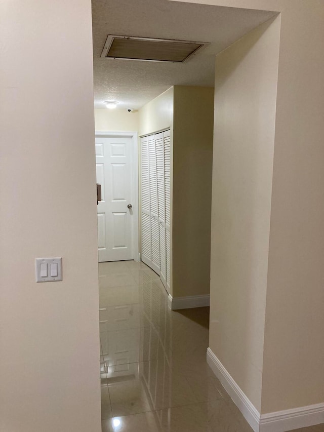 hall featuring light tile patterned floors