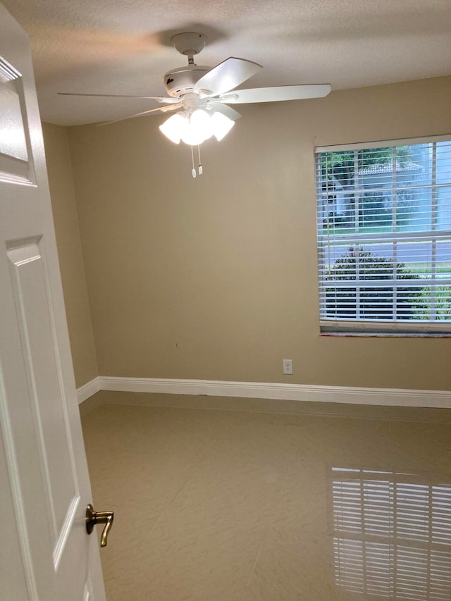 unfurnished room featuring a textured ceiling and ceiling fan