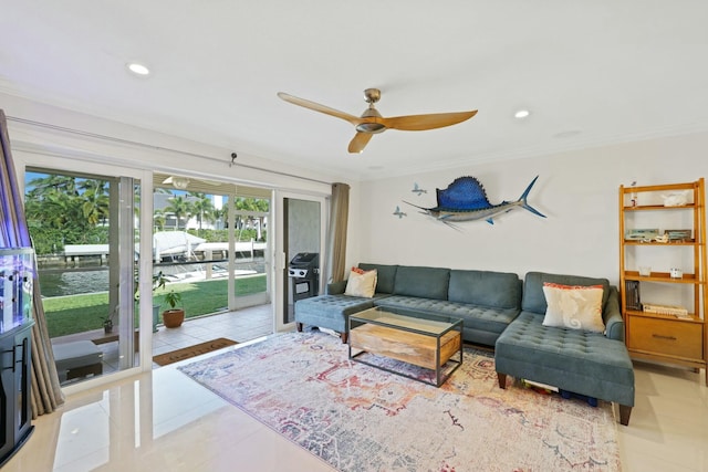 tiled living room with ceiling fan and ornamental molding