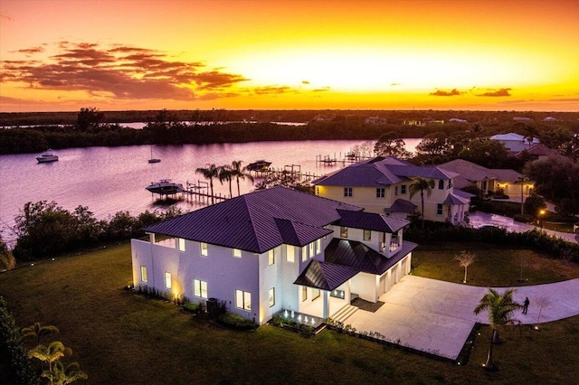 aerial view at dusk with a water view