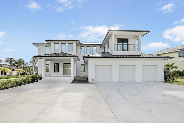 view of front of home featuring a balcony and a garage