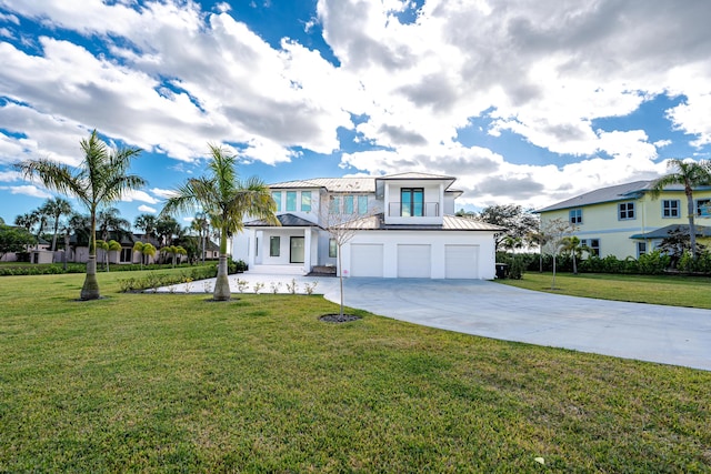 view of front of property featuring a front yard and a garage