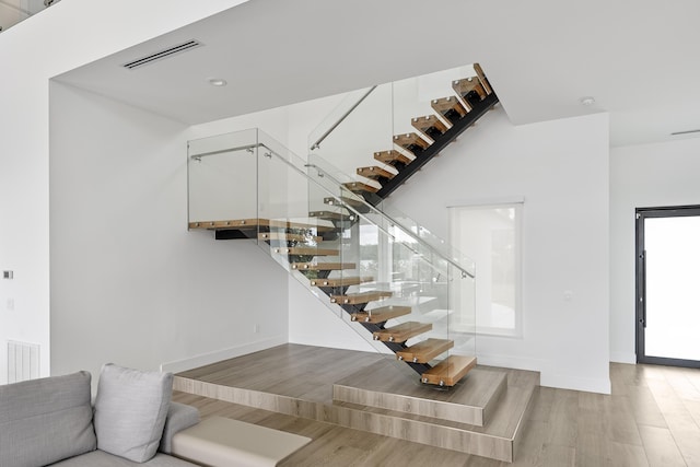 staircase featuring hardwood / wood-style floors and breakfast area