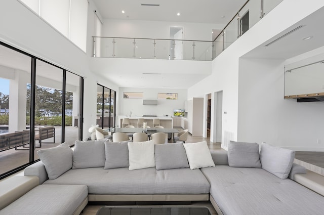 living room featuring a high ceiling and hardwood / wood-style floors