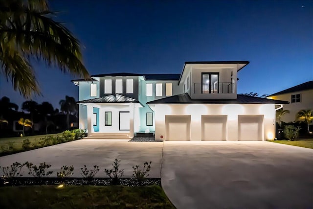 view of front of home featuring a balcony and a garage