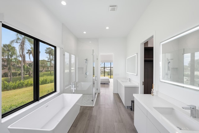 bathroom with vanity, separate shower and tub, and wood-type flooring