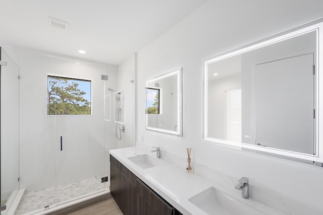 bathroom featuring vanity, an enclosed shower, and hardwood / wood-style flooring