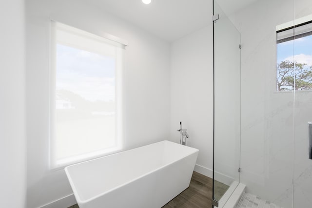 bathroom featuring separate shower and tub