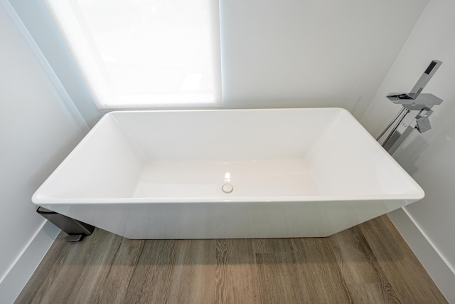 interior space featuring a washtub and hardwood / wood-style flooring